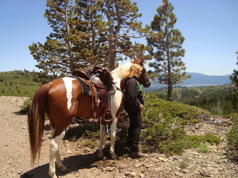 Woman with horse in mountains